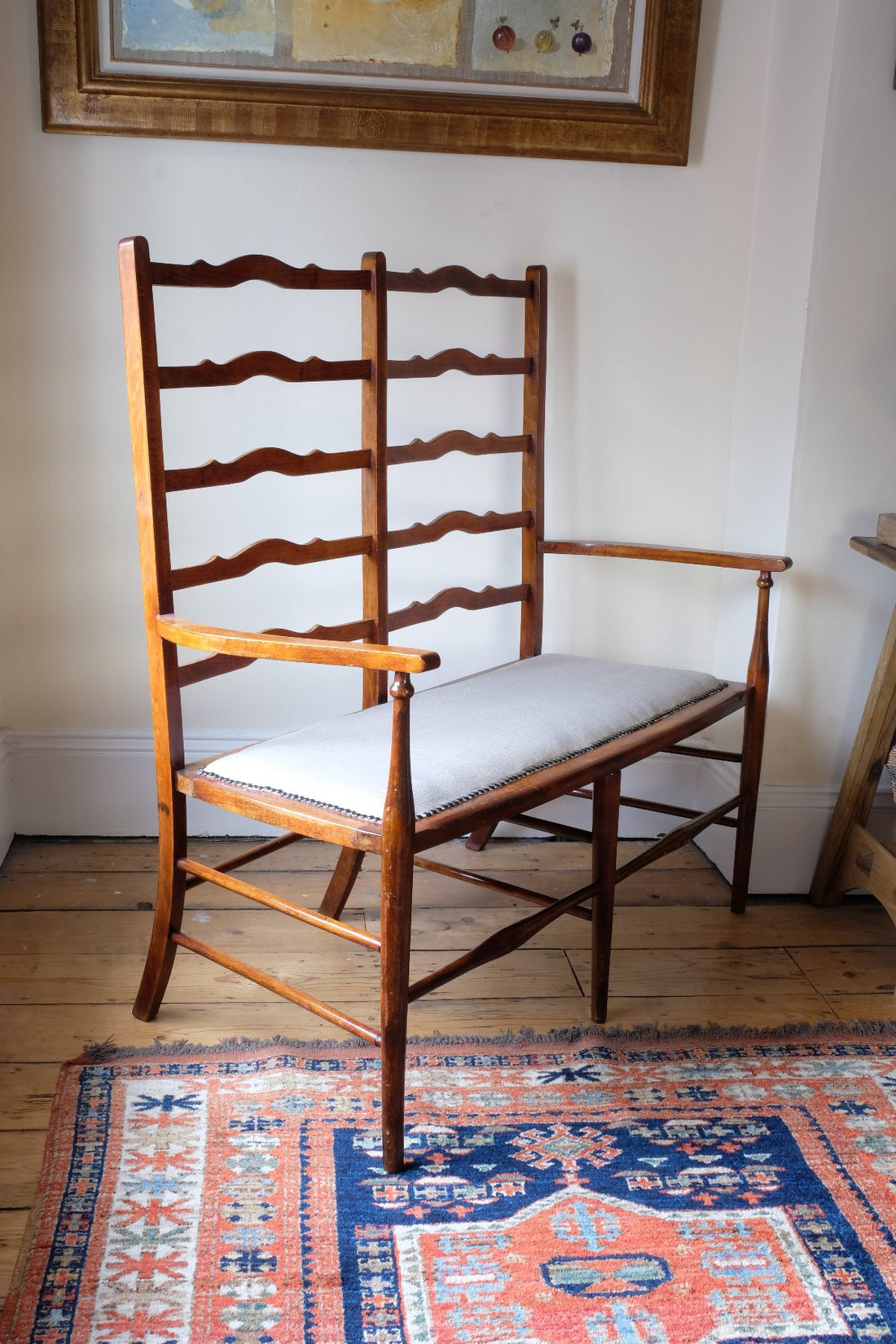 19th century English beech ladder-back bench with linen upholstered horsehair seat and waved slats