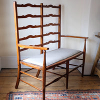 19th century English beech ladder-back bench with linen upholstered horsehair seat and waved slats