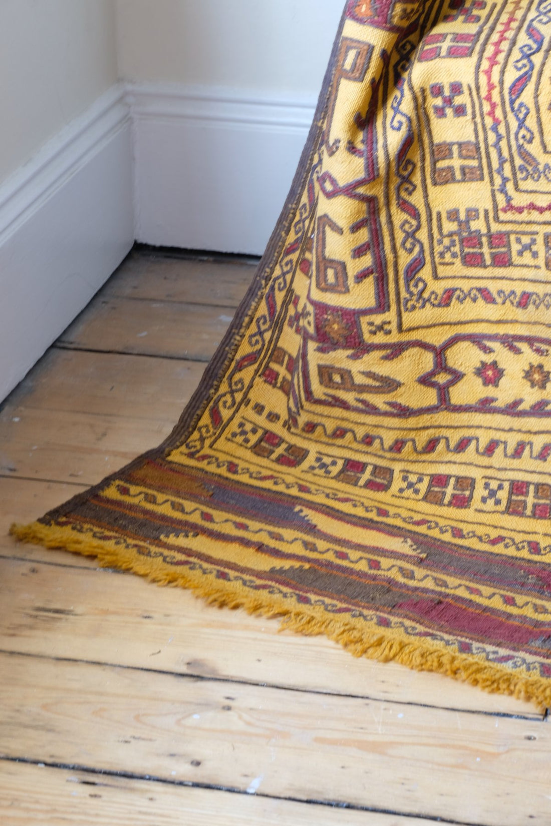 Fringes on the Antique Anatolian kilim rug with saffron ground and geometric motifs