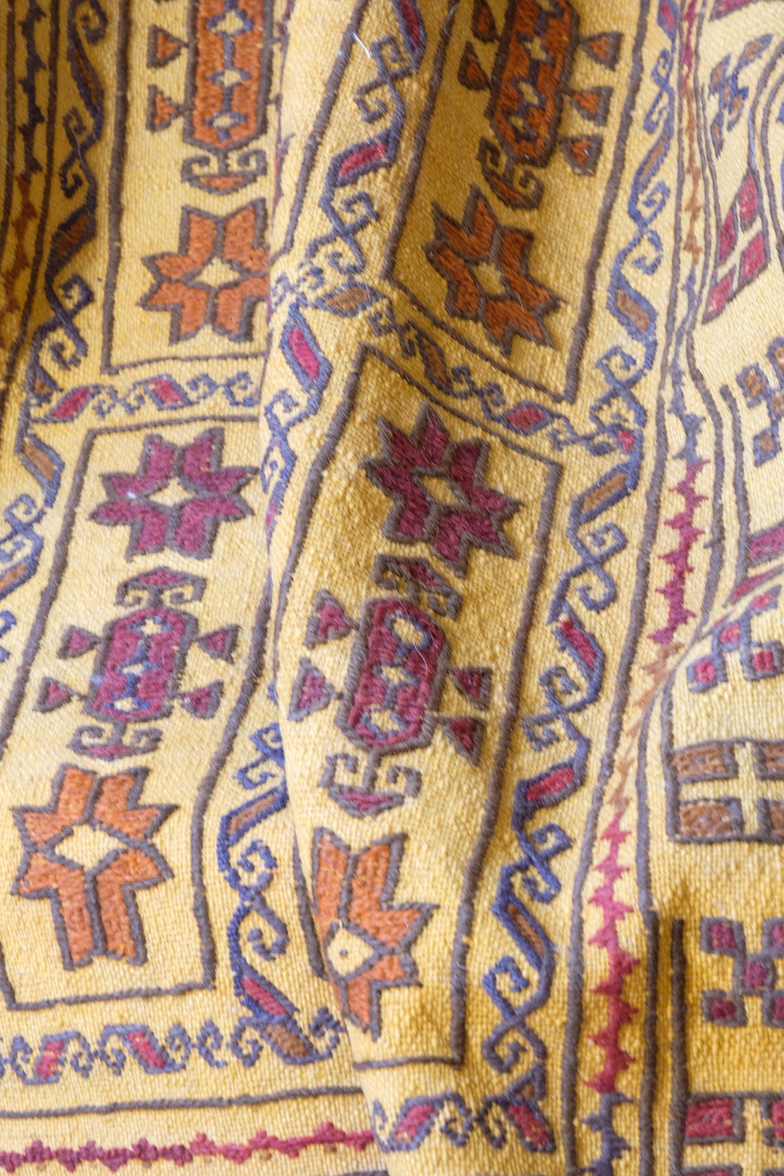 Antique Anatolian kilim rug with saffron ground and geometric motifs