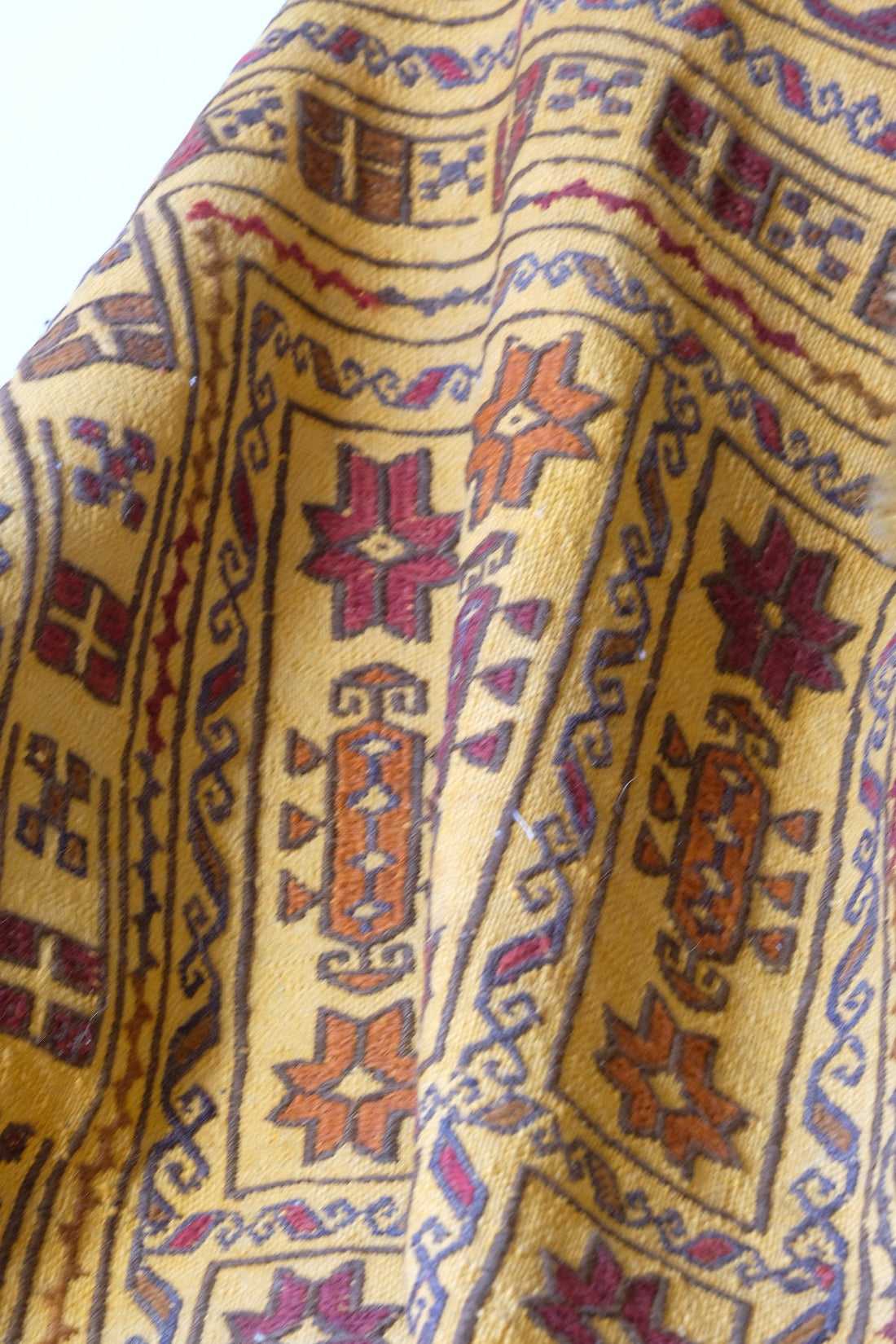close up of the Antique Anatolian kilim rug with saffron ground and geometric motifs