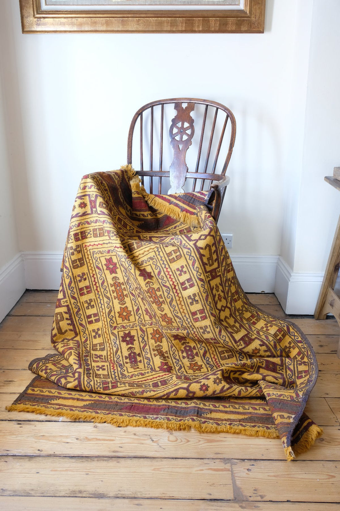 Draped over a chair - Antique Anatolian kilim rug with saffron ground and geometric motifs
