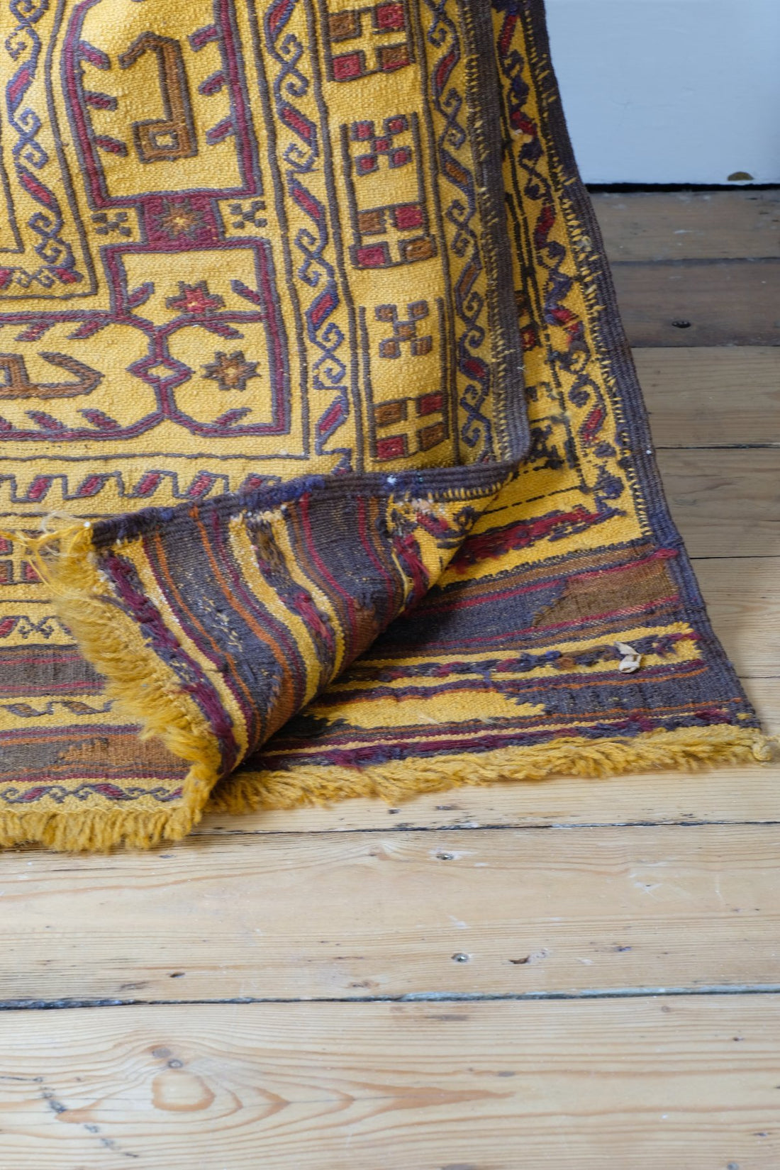 back of an Antique Anatolian kilim rug with saffron ground and geometric motifs