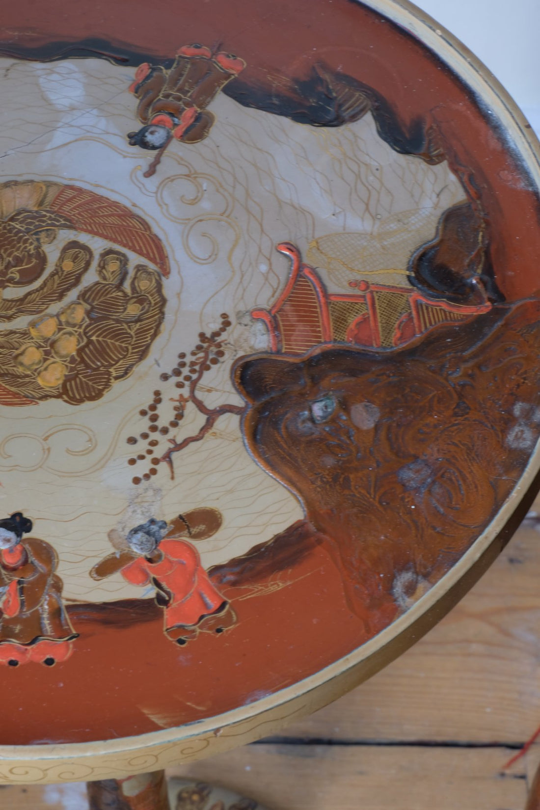 close up o a Pair of antique chinoiserie lacquered pedestal side tables with hand painted oriental scenes and gilt detailing