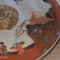 close up o a Pair of antique chinoiserie lacquered pedestal side tables with hand painted oriental scenes and gilt detailing