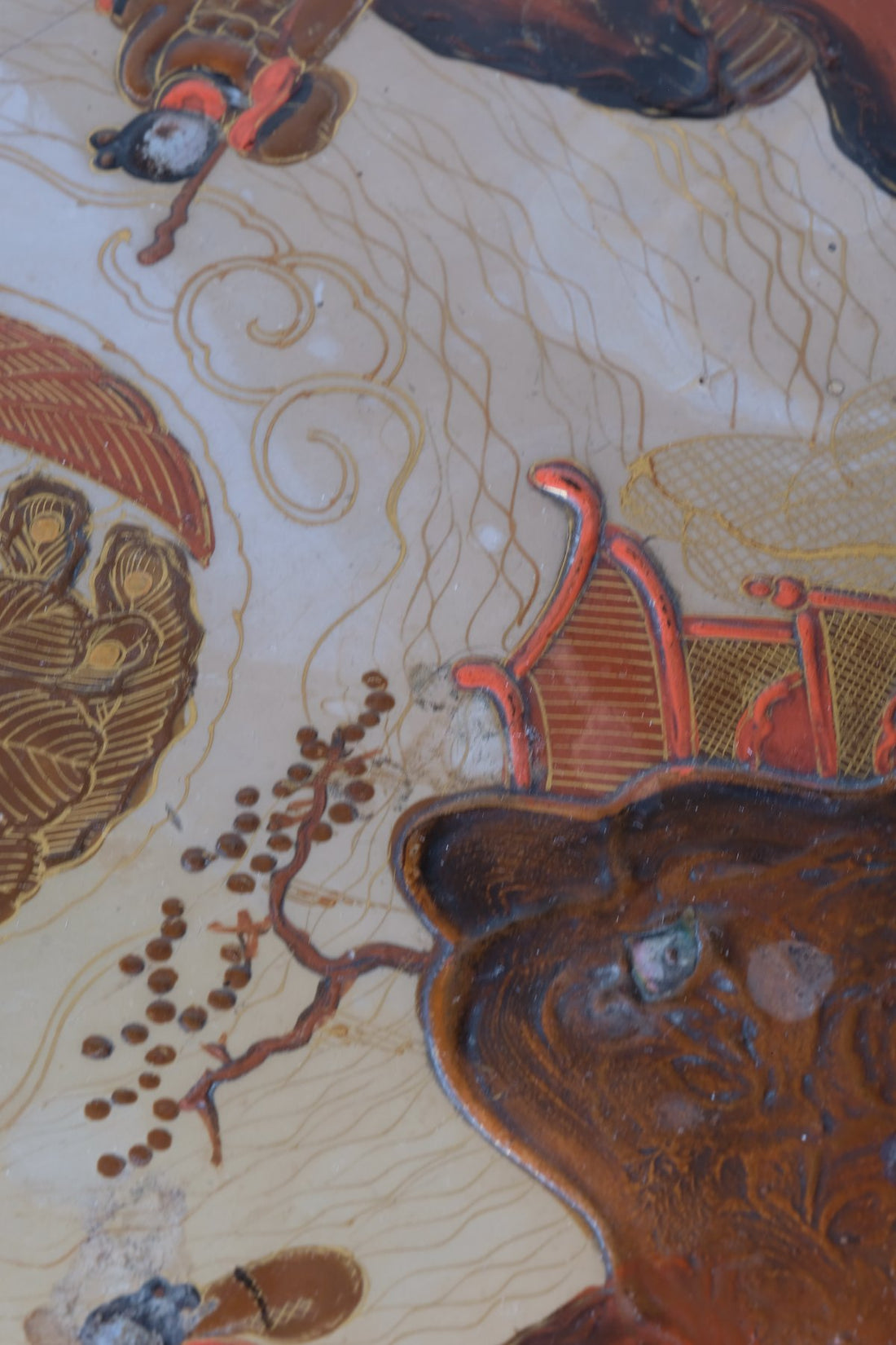 Close up of a Pair of antique chinoiserie lacquered pedestal side tables with hand painted oriental scenes and gilt detailing