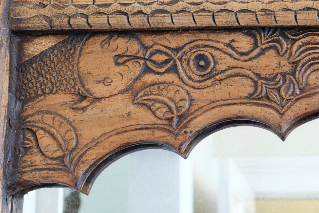 Close up of the carved fish - large antique Indian carved hardwood mirror with Indo-Islamic Moorish arch detail