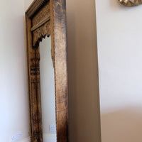 side view on a large antique Indian carved hardwood mirror with Indo-Islamic Moorish arch detail