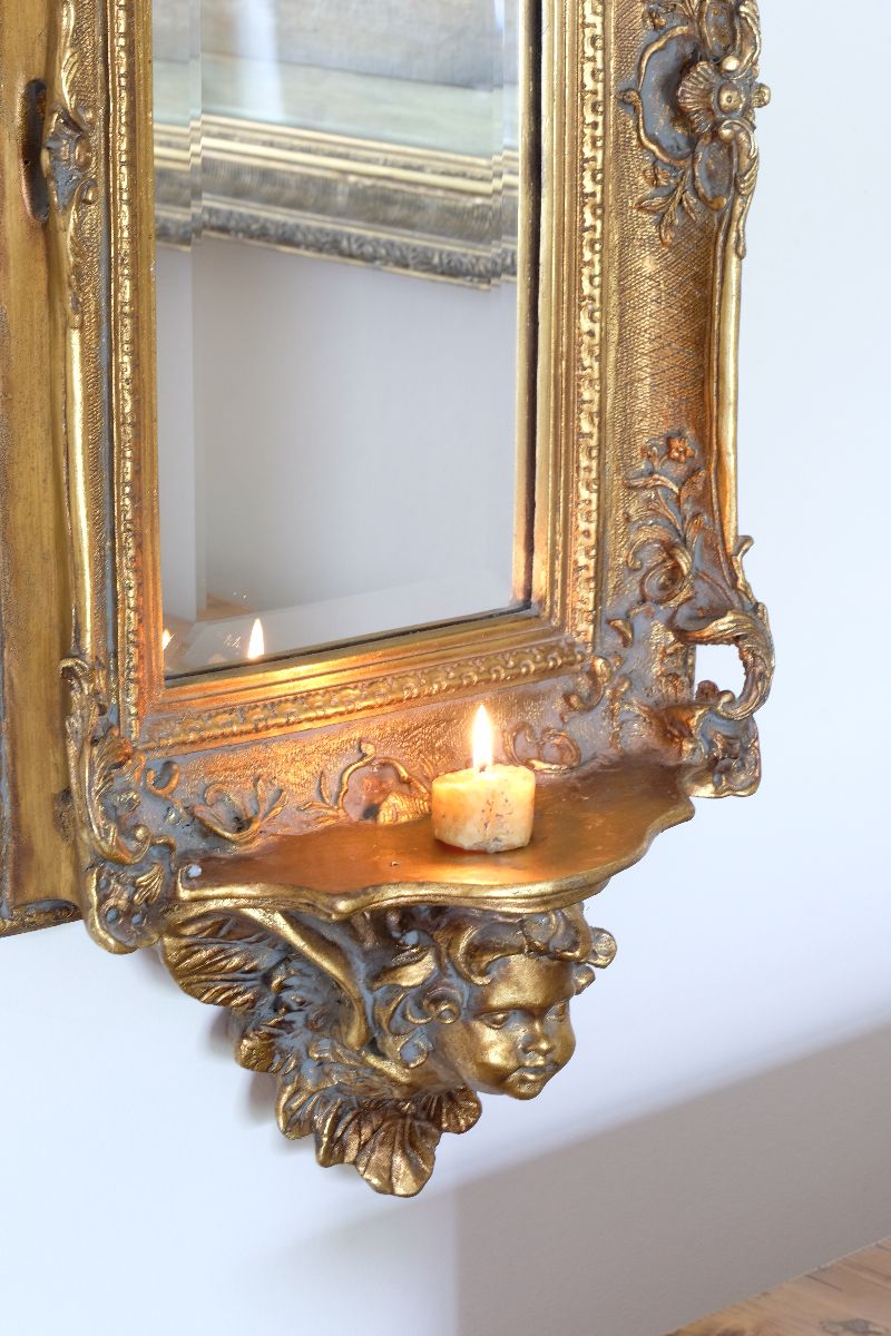 Late Victorian gilt wall mirror with original bevelled mirror plate and cherub shelf detail
