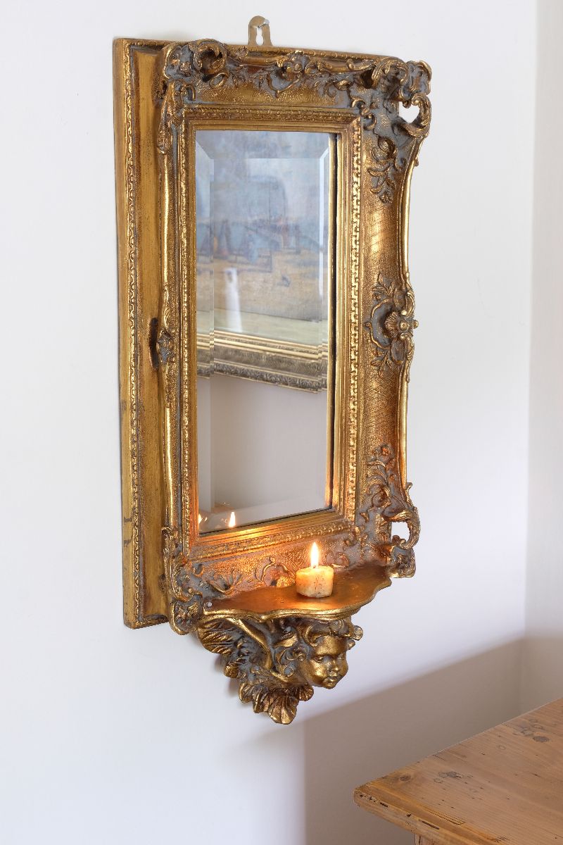 Late Victorian gilt wall mirror with original bevelled mirror plate and cherub shelf detail