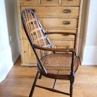 View of the curved back on a Rare Edwardian bentwood lattice back armchair attributed to Jas Shoolbred with pierced Arts & Crafts design