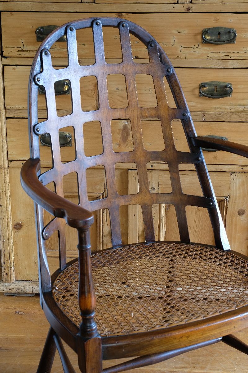 View of the curved notched arms on a Rare Edwardian bentwood lattice back armchair attributed to Jas Shoolbred with pierced Arts & Crafts design 