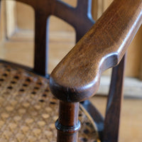 Close up view of the curved notched arms on a Rare Edwardian bentwood lattice back armchair attributed to Jas Shoolbred with pierced Arts & Crafts design 