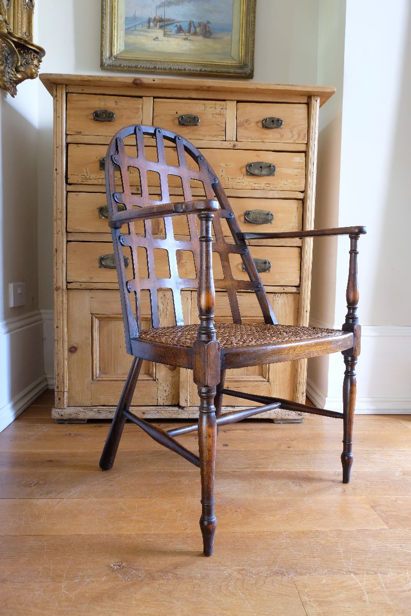 Low view on a Rare Edwardian bentwood lattice back armchair attributed to Jas Shoolbred with pierced Arts & Crafts design 