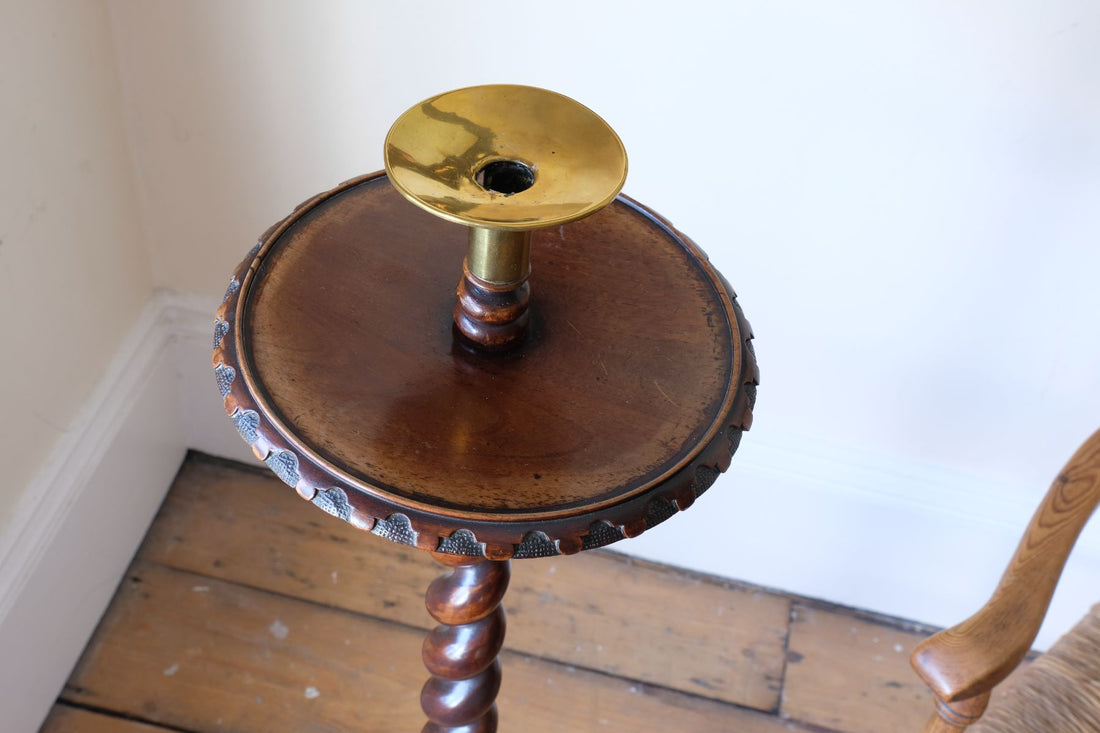 Table top and brass sconce of a Rare Victorian walnut barley twist candle and wine stand with brass candle sconce and carved foliate decoration, circa 1870Rare Victorian walnut barley twist candle and wine stand with brass candle sconce and carved foliate decoration, circa 1870