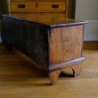 Side view of the raised plint on a Early 19th Century English Elm Six Plank Coffer Chest With Internal Till