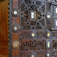 Close up on the relief carved and pierced fretwork decoration - Antique Kutch Damchiya dowry chest with mirror inlay and carved hardwood fretwork, Gujarat c.1900–1930