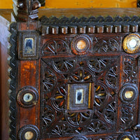 Architectural cresting with carved corner finials on an Antique Kutch Damchiya dowry chest with mirror inlay and carved hardwood fretwork, Gujarat c.1900–1930