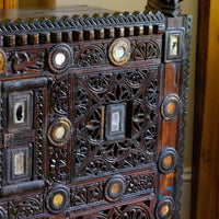 Architectural cresting with carved corner finials on an Antique Kutch Damchiya dowry chest with mirror inlay and carved hardwood fretwork, Gujarat c.1900–1930