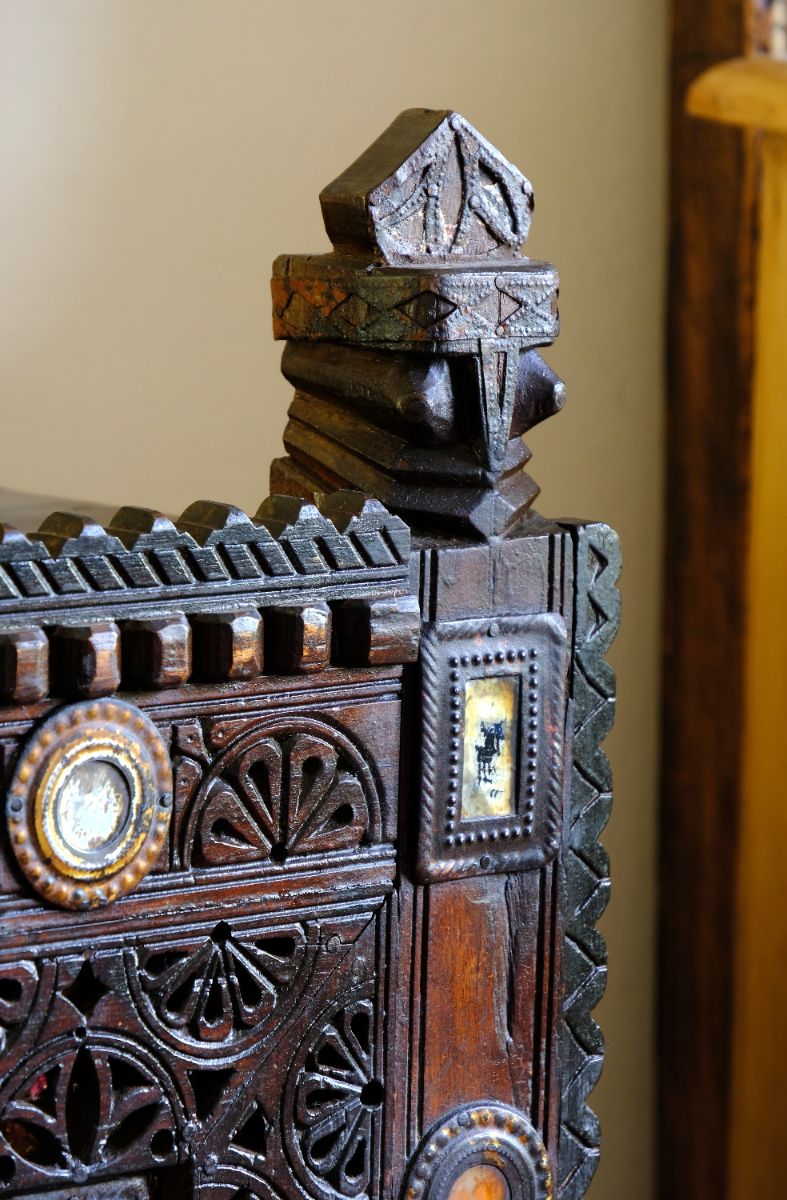 Architectural cresting with carved corner finials on an Antique Kutch Damchiya dowry chest with mirror inlay and carved hardwood fretwork, Gujarat c.1900–1930