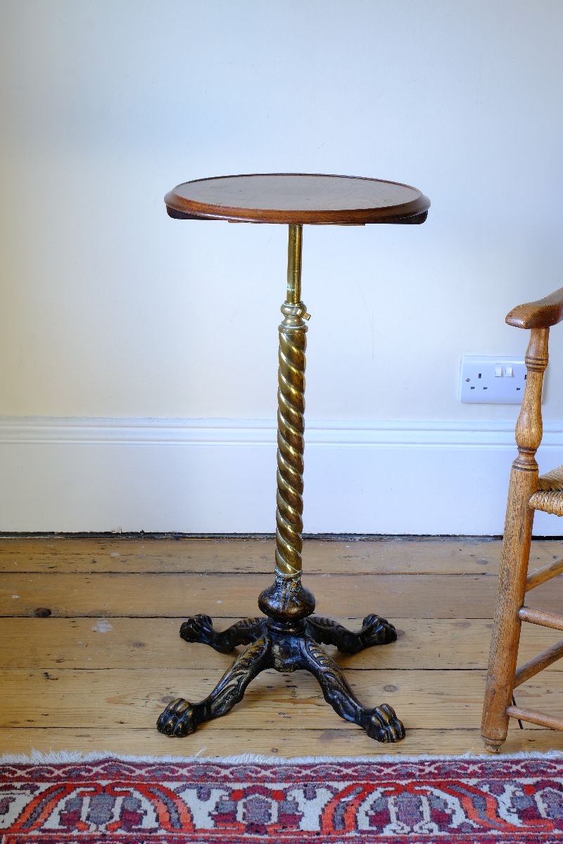 Close up - Antique Victorian brass telescopic wine table with mahogany top and lion’s paw feet