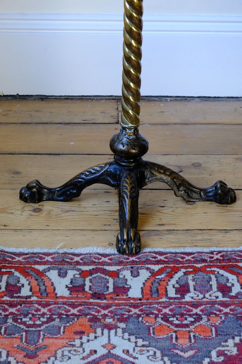 cloase up of base on an Antique Victorian brass telescopic wine table with mahogany top and lion’s paw feet