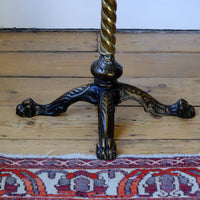 cloase up of base on an Antique Victorian brass telescopic wine table with mahogany top and lion’s paw feet