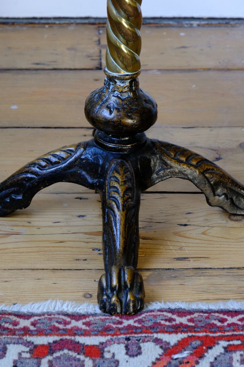 Lions paw close up on an Antique Victorian brass telescopic wine table with mahogany top and lion’s paw feet