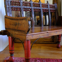 Side carved arm detail on a Late 19th Century Gujarati Hardwood Hall Bench with Original Polychrome Finish, Turned Gallery Back and Brass Rosette Mounts 