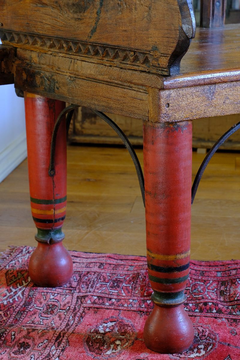 The surviving original terracotta polychrome decoration 
 on a Late 19th Century Gujarati Hardwood Hall Bench with Original Polychrome Finish, Turned Gallery Back and Brass Rosette Mounts