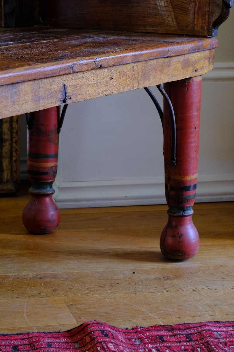 The surviving original terracotta polychrome decoration 
 on a Late 19th Century Gujarati Hardwood Hall Bench with Original Polychrome Finish, Turned Gallery Back and Brass Rosette Mounts