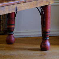The surviving original terracotta polychrome decoration 
 on a Late 19th Century Gujarati Hardwood Hall Bench with Original Polychrome Finish, Turned Gallery Back and Brass Rosette Mounts