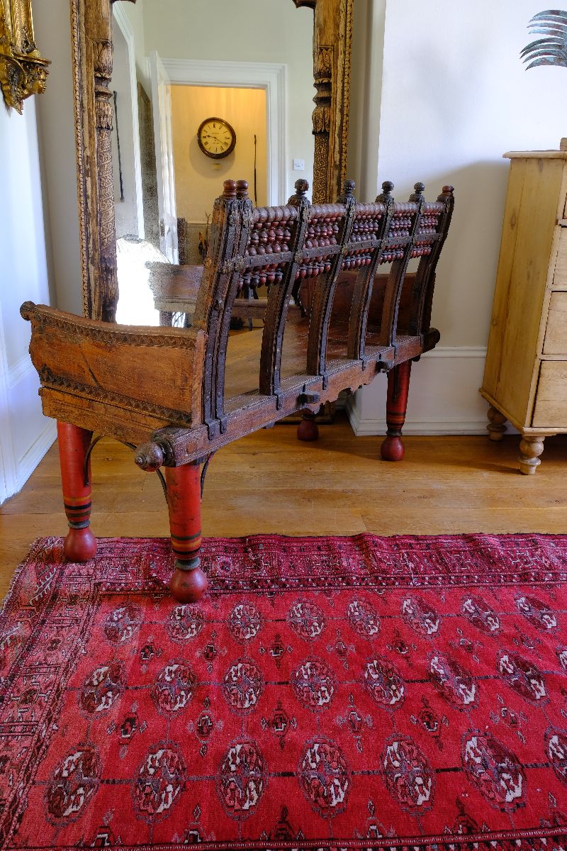 View of the back on a Late 19th Century Gujarati Hardwood Hall Bench with Original Polychrome Finish, Turned Gallery Back and Brass Rosette Mounts