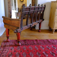 View of the back on a Late 19th Century Gujarati Hardwood Hall Bench with Original Polychrome Finish, Turned Gallery Back and Brass Rosette Mounts