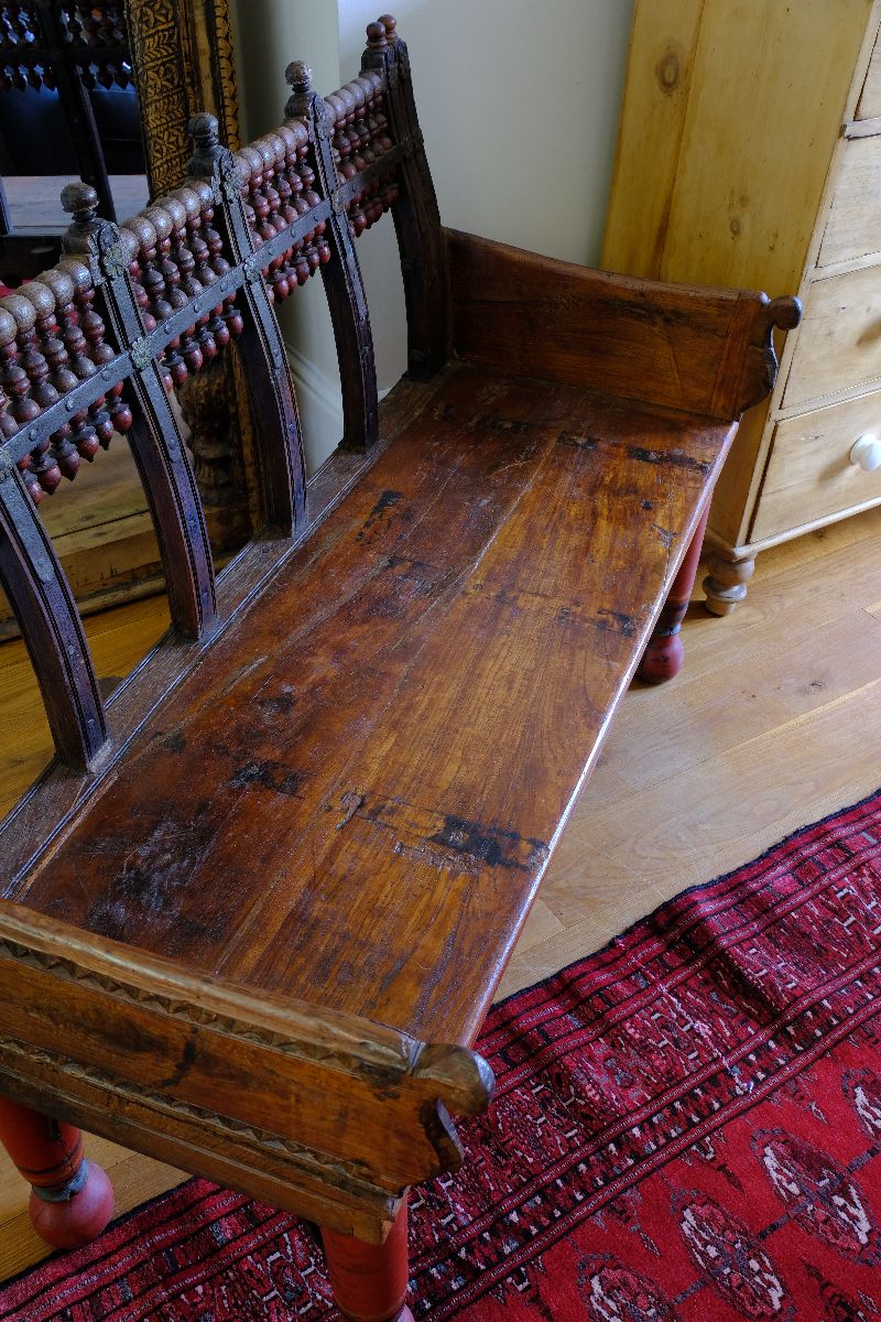 The old bench seat on a Late 19th Century Gujarati Hardwood Hall Bench with Original Polychrome Finish, Turned Gallery Back and Brass Rosette Mounts