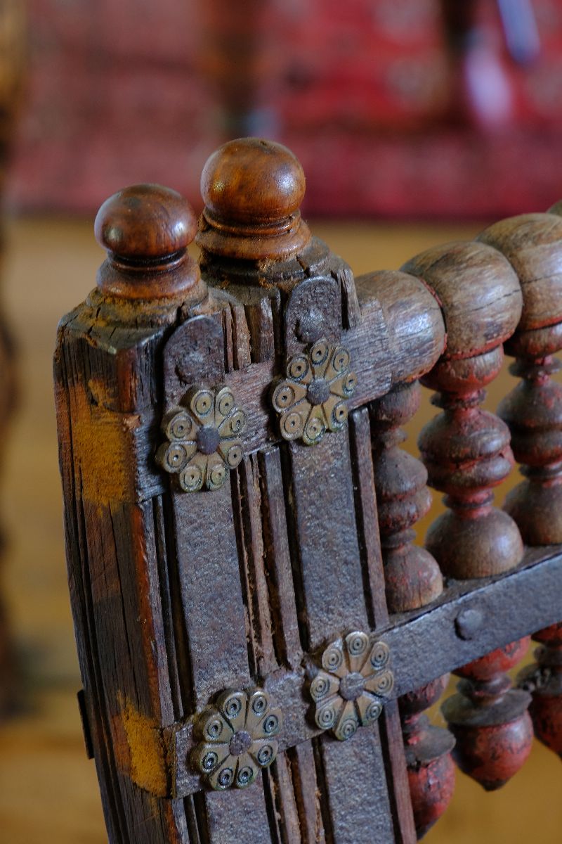 The forged iron straps with decorative brass rosette mounts - Late 19th Century Gujarati Hardwood Hall Bench with Original Polychrome Finish, Turned Gallery Back and Brass Rosette Mounts