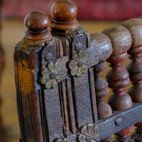 The forged iron straps with decorative brass rosette mounts - Late 19th Century Gujarati Hardwood Hall Bench with Original Polychrome Finish, Turned Gallery Back and Brass Rosette Mounts