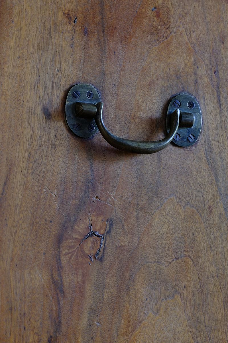 Brass drop handle on the Camphor Wood Campaign Secretaire Chest by Phelps Ltd. with Fitted Writing Desk and Original Label