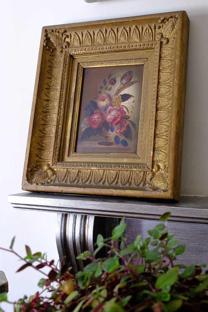 Angled view of an  English School antique oil on board still life of garden flowers in original gilt carved frame
