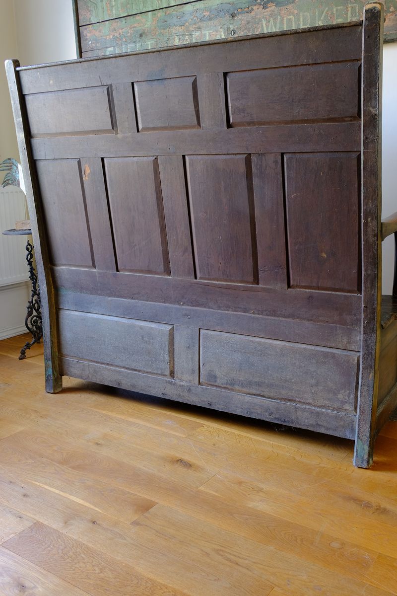 back panel raised and fielded construction of the 19th Century Welsh Oak Settle Bench with Painted Panels and Storage Chest