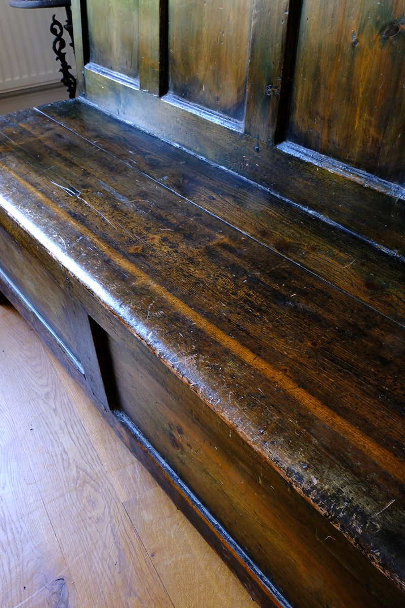 Seat close up on a 19th Century Welsh Oak Settle Bench with Painted Panels and Storage Chest