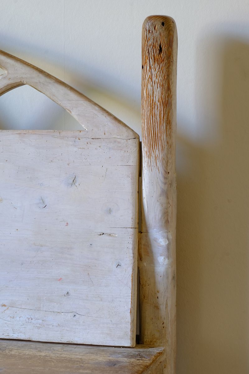 Close up of the worn back post on a 19th Century Gothic Painted Pine Hall Bench with Gothic Fretwork and Original Painted Finish