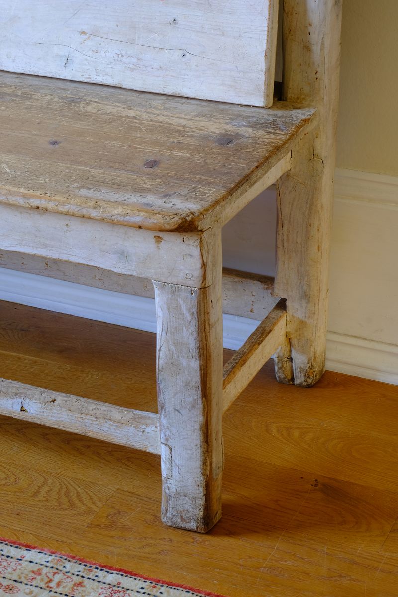 Corner leg and worn seat shot on a 19th Century Gothic Painted Pine Hall Bench with Gothic Fretwork and Original Painted Finish