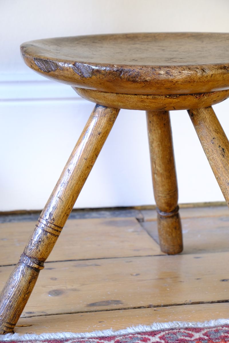 side profile on an Early 19th Century Vernacular Three Legged Sycamore Dairy Stool with Dished Seat
