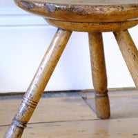 side profile on an Early 19th Century Vernacular Three Legged Sycamore Dairy Stool with Dished Seat