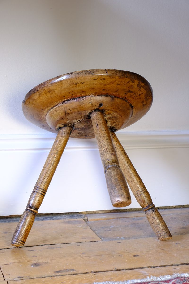 pronounced under-seat boss on this Early 19th Century Vernacular Three Legged Sycamore Dairy Stool with Dished Seat