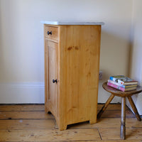Side cut single panel on a Late Victorian pine marble top bedside cupboard with Carrara marble and concealed brass pivot hinges