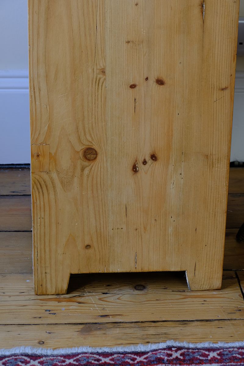 close up of the cut side panel on a Late Victorian pine marble top bedside cupboard with Carrara marble and concealed brass pivot hinges
