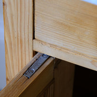 Close up of the original pivot hinge assembly on a Late Victorian pine marble top bedside cupboard with Carrara marble and concealed brass pivot hinges