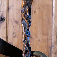 Folk art walking stick in a naturalist root wood form